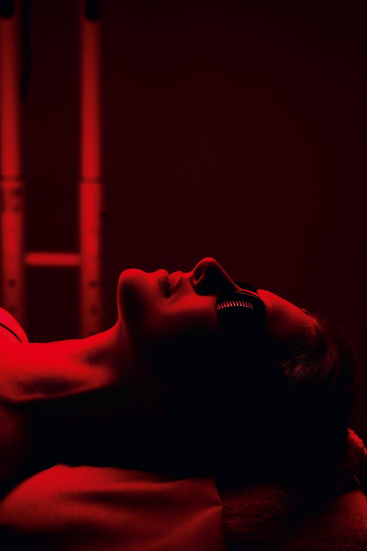 A person resting under red light therapy with the eyes shielded
